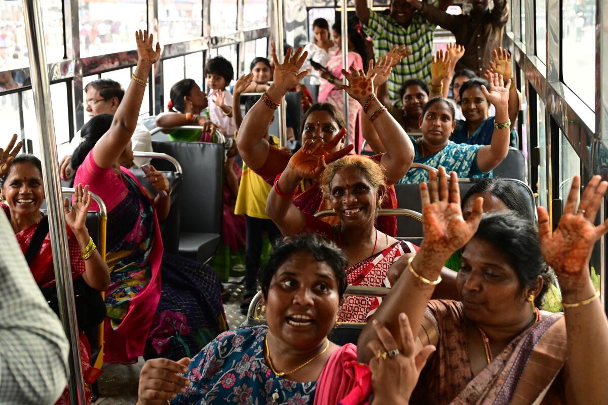 Woman travel in a government-run bus in Vijayawada.